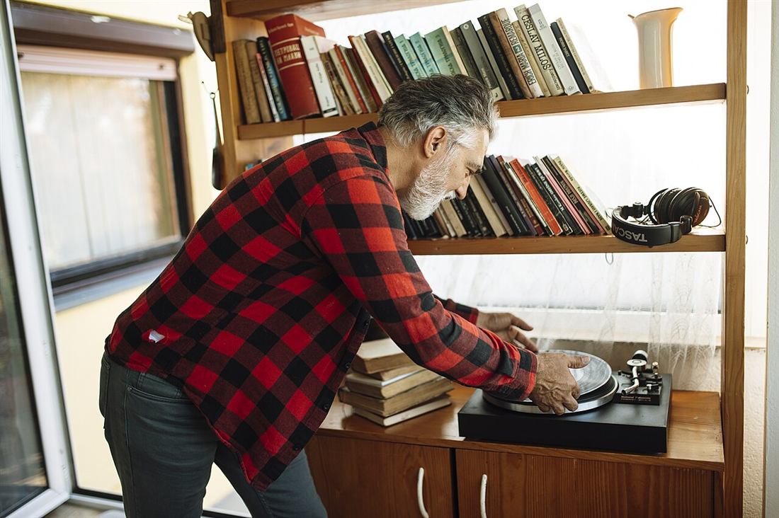 Caballero poniendo un disco en su tocadiscos